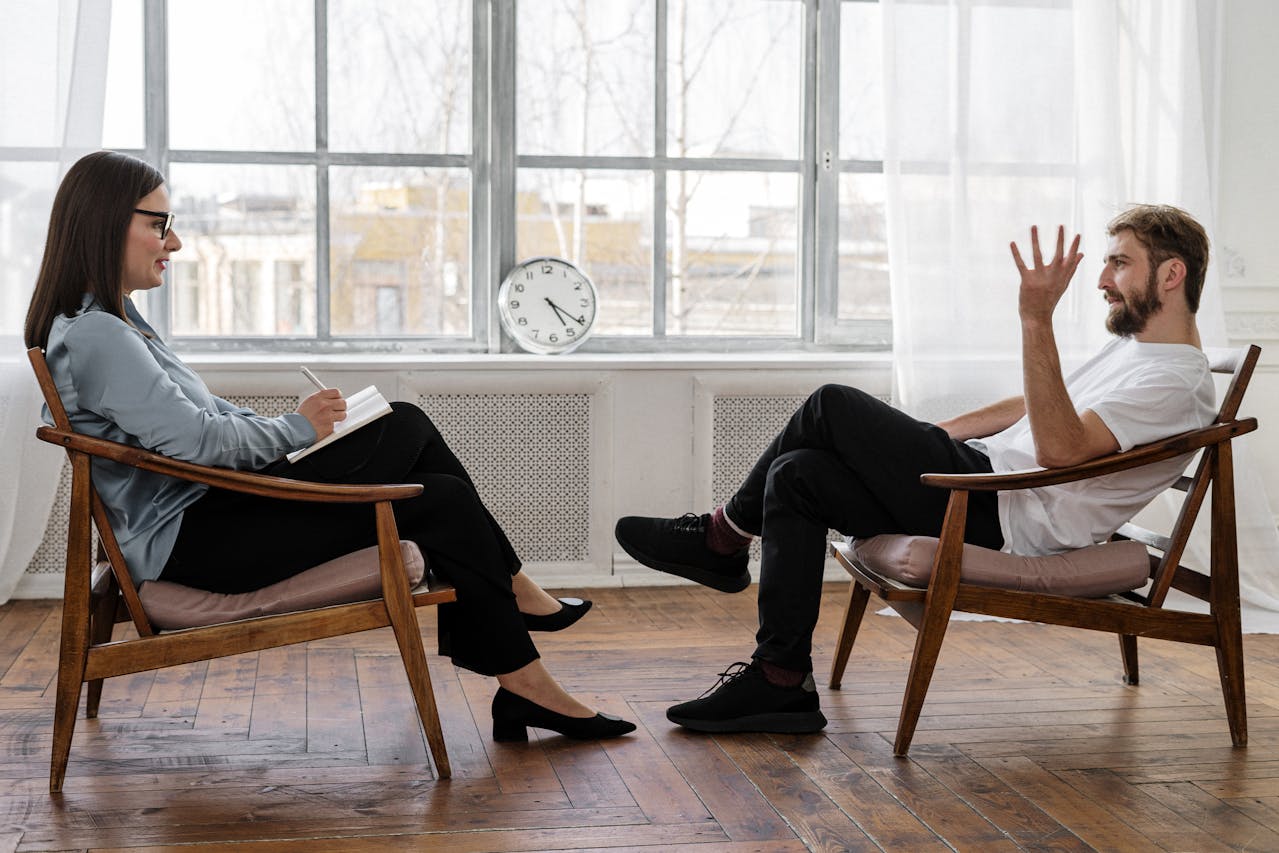 A man talking to his therapist in her office