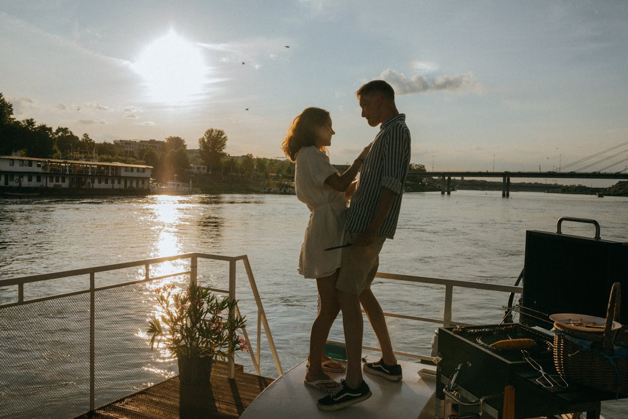 Man and woman outside standing next to water