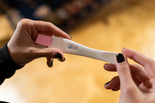 Woman's hands holding a pregnancy test